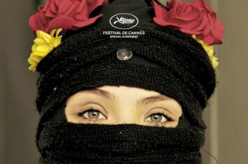 Filmcover von »Mi país imaginario«, eine vermummte Aktivistin mit Blumenschmuck